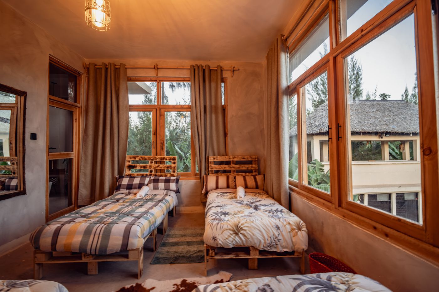 Shared student room at Ubuntu with individual beds and large windows