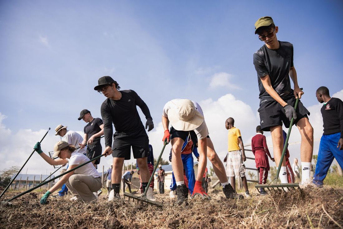 The cohort working the school farm